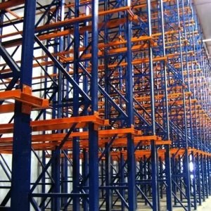 Rows of tall, empty industrial storage racks with blue frames and orange beams showcase efficient warehouse solutions inside a spacious facility.