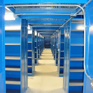 A long corridor of empty blue metal shelving units in a well-lit industrial storage space, showcasing modern warehouse solutions.