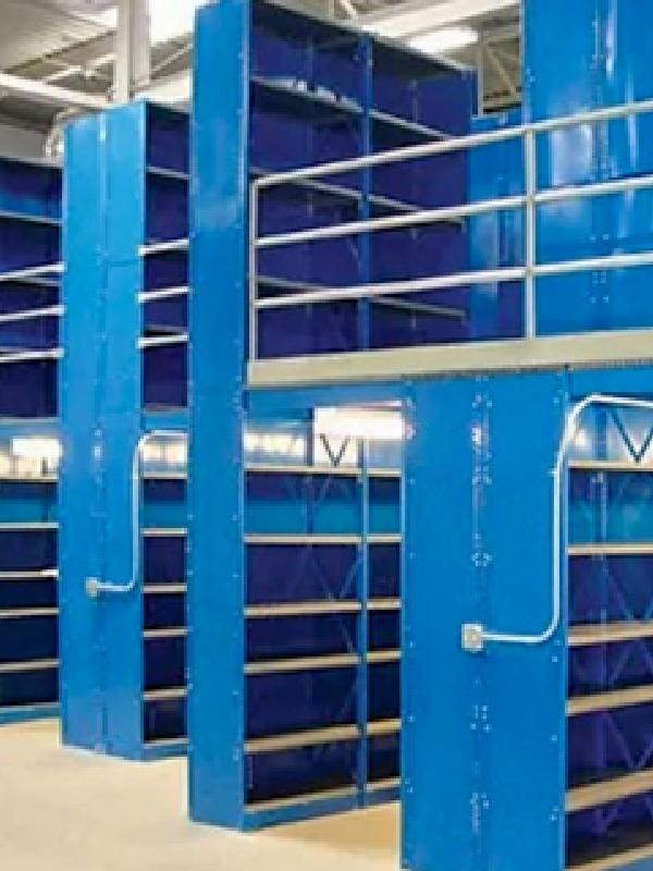 Blue metal industrial shelving units with multiple levels are shown inside a warehouse or storage facility, providing sturdy and organized industrial shelving solutions.